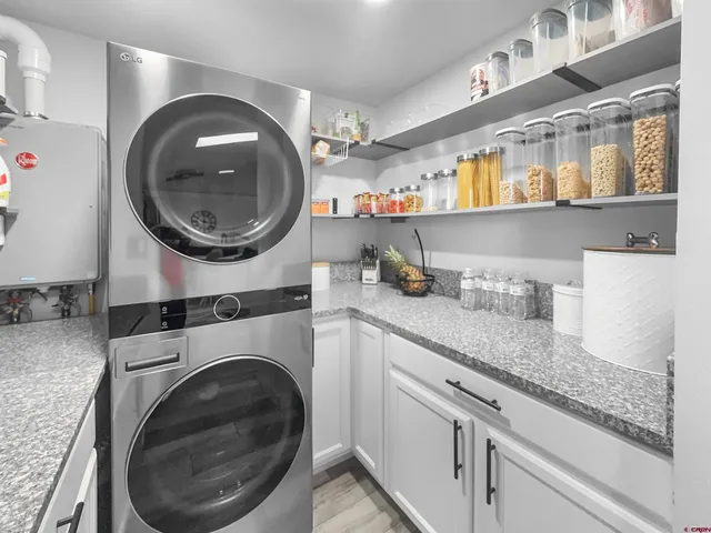 a kitchen with stainless steel appliances granite countertop a sink and a stove