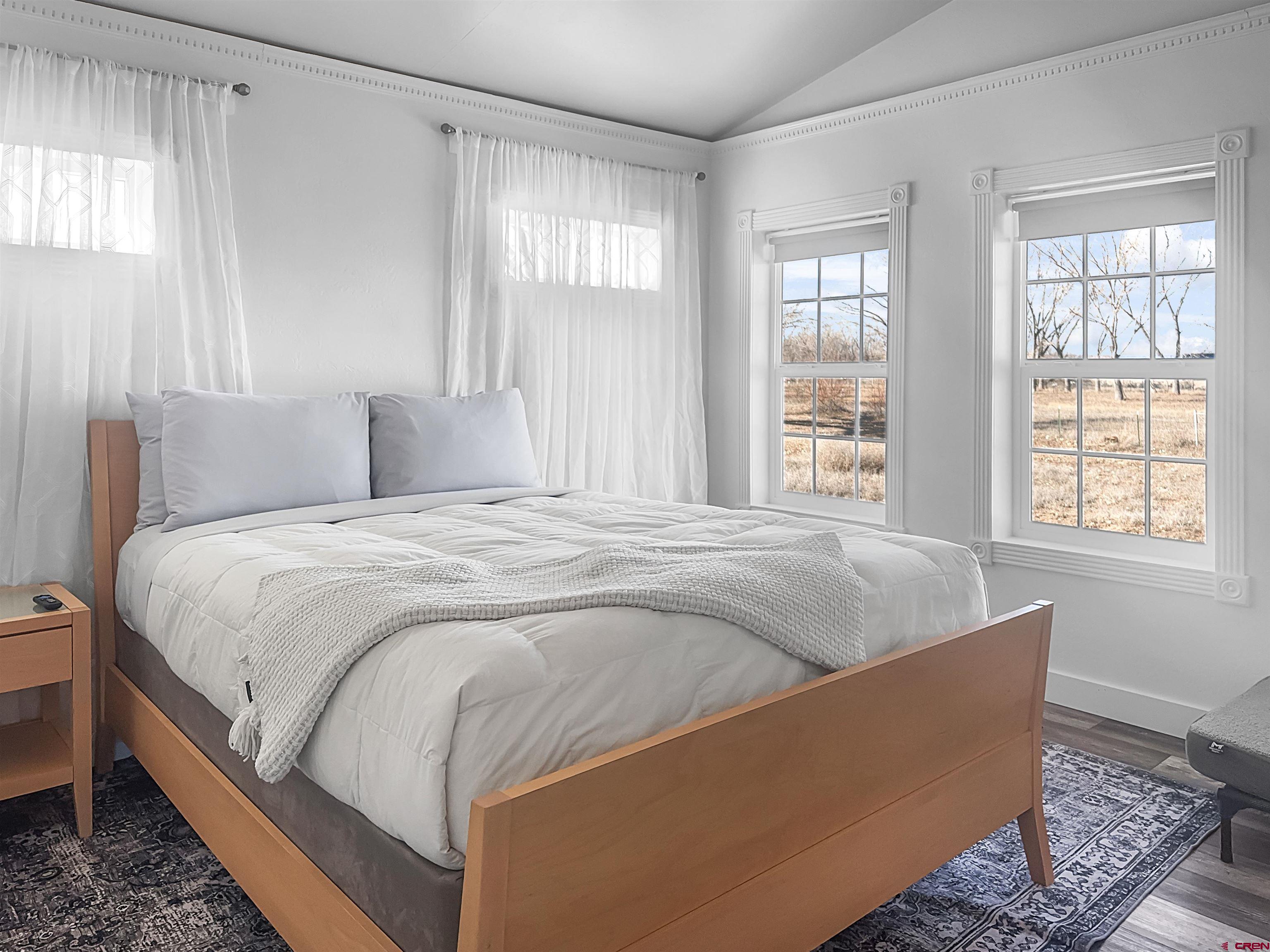 10880 Road 26 Cortez, CO 81321 - Photo 30 of 43 a bed sitting in a bedroom next to a window