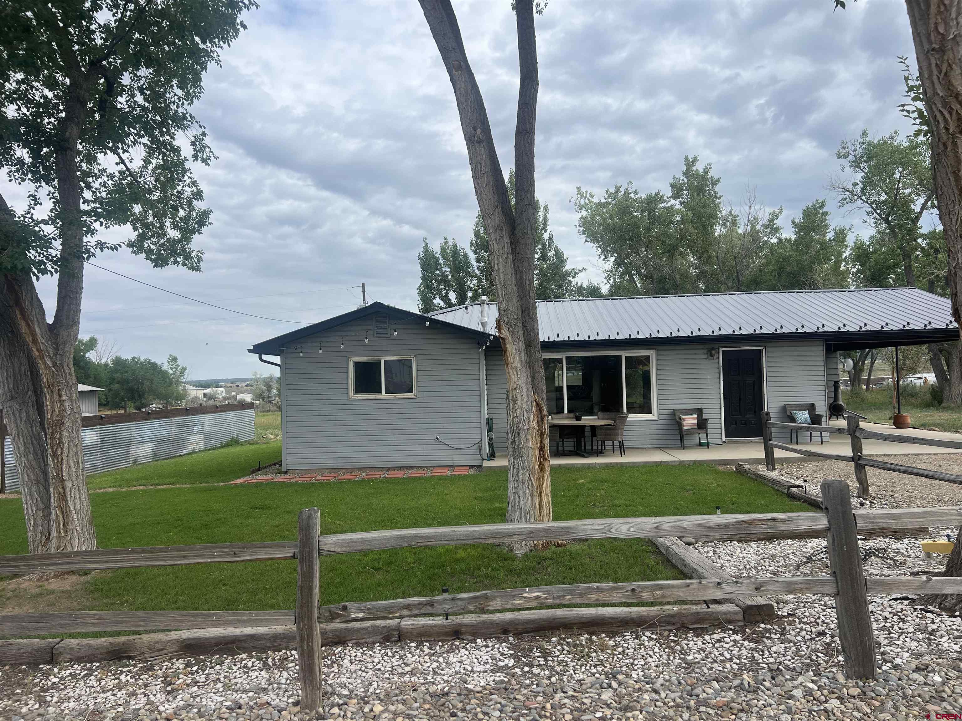 10880 Road 26 Cortez, CO 81321 - Photo 3 of 43 a view of a yard in front of a house with large trees