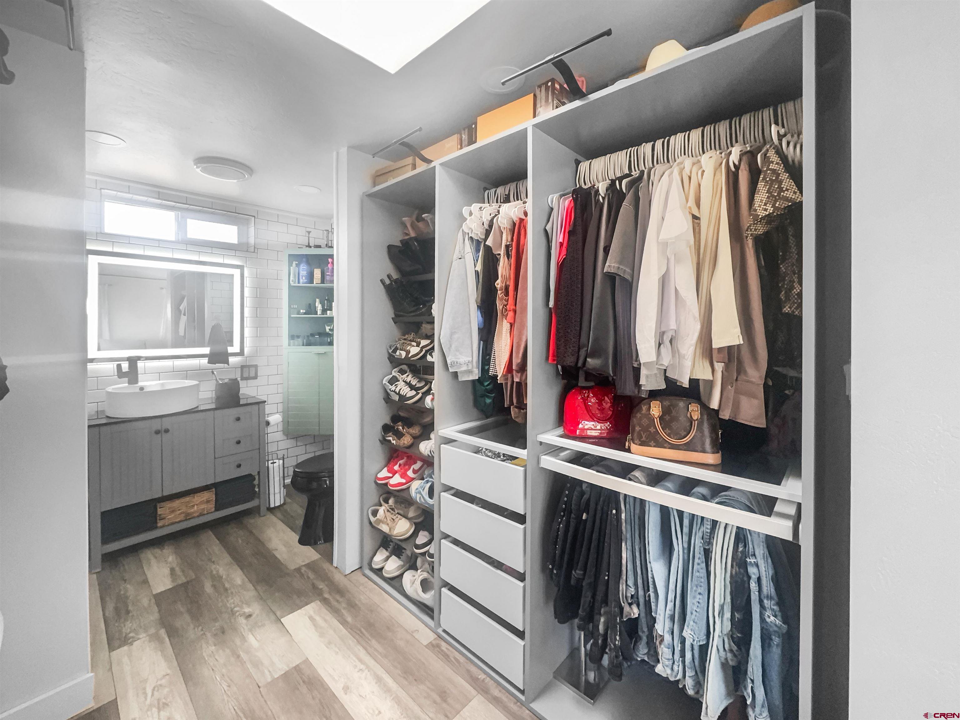 10880 Road 26 Cortez, CO 81321 - Photo 32 of 43 a view of walk in closet with clothes and shoes