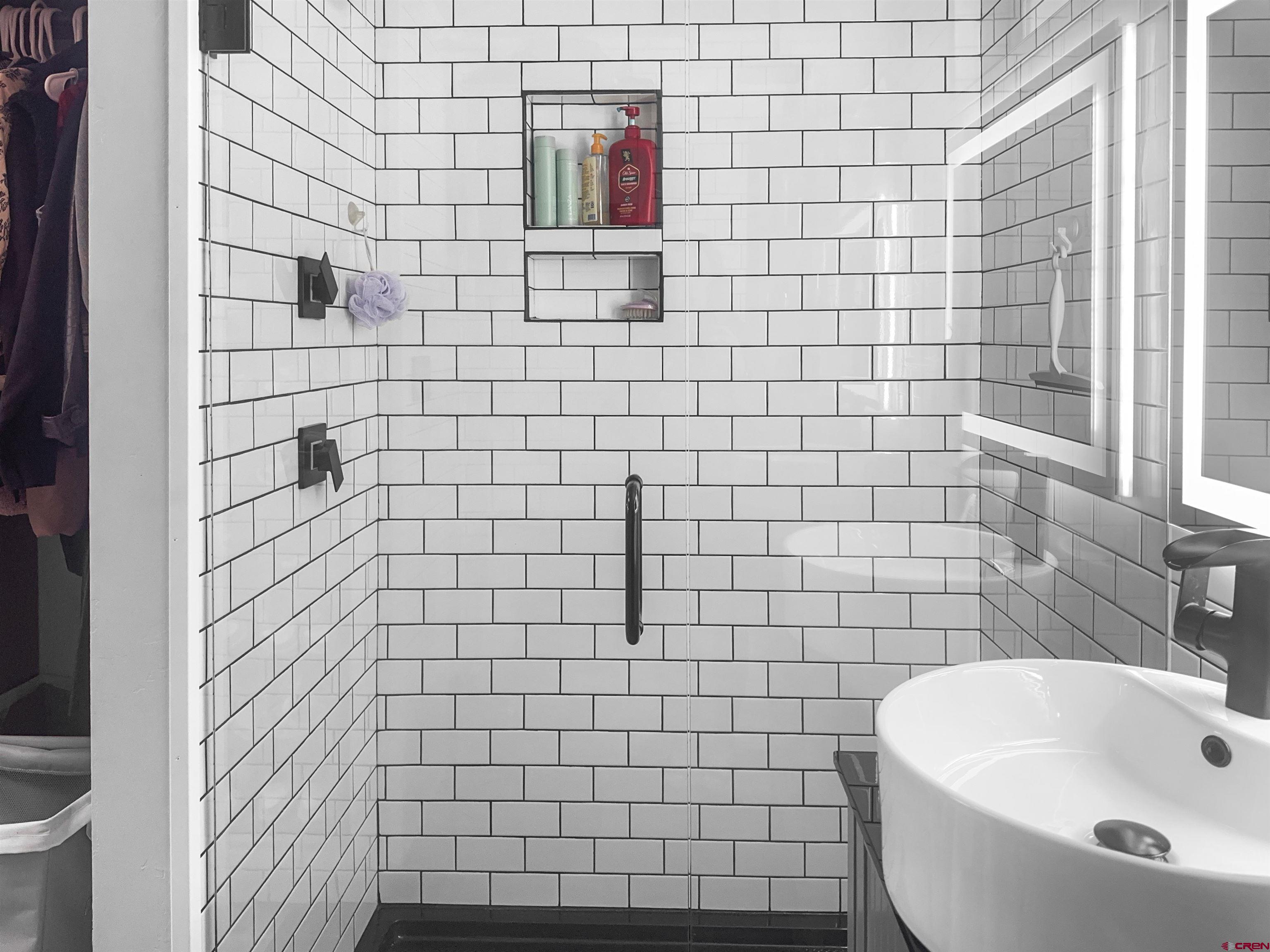 10880 Road 26 Cortez, CO 81321 - Photo 34 of 43 a bathroom with a white sink a toilet and shower