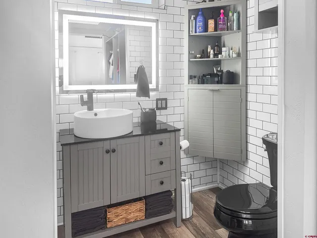 a bathroom with a sink a toilet and a mirror