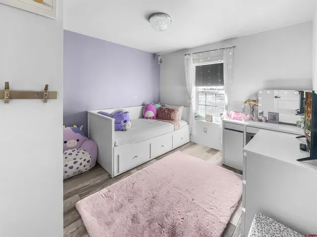 a bedroom with a bed and dresser