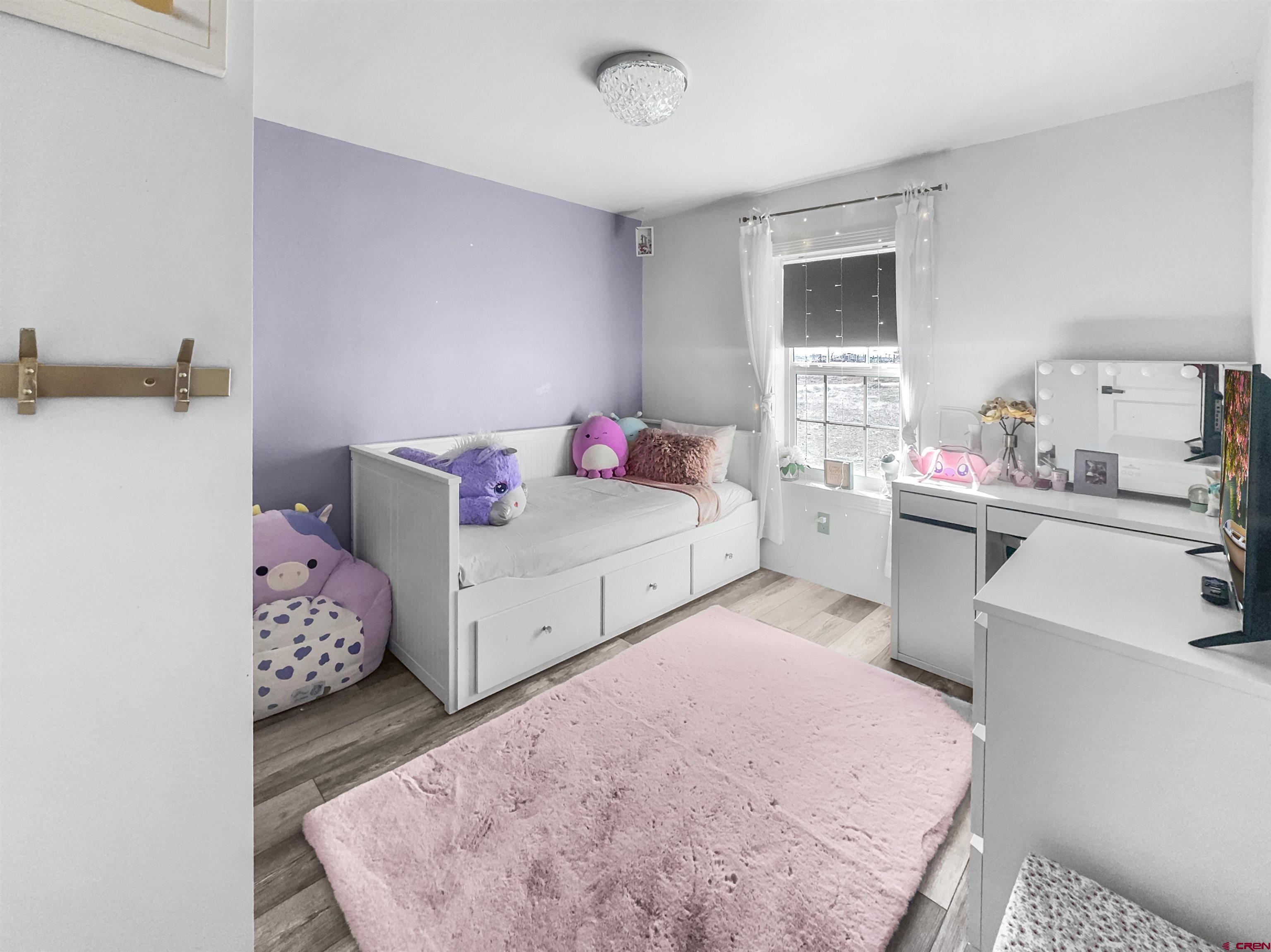 10880 Road 26 Cortez, CO 81321 - Photo 37 of 43 a bedroom with a bed and dresser