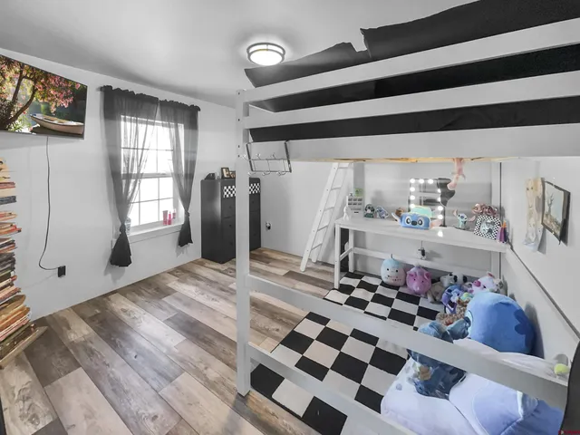 a kitchen with stainless steel appliances kitchen island granite countertop a sink and a refrigerator