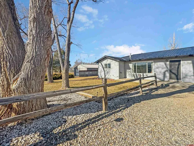 a view of a house with wooden fence