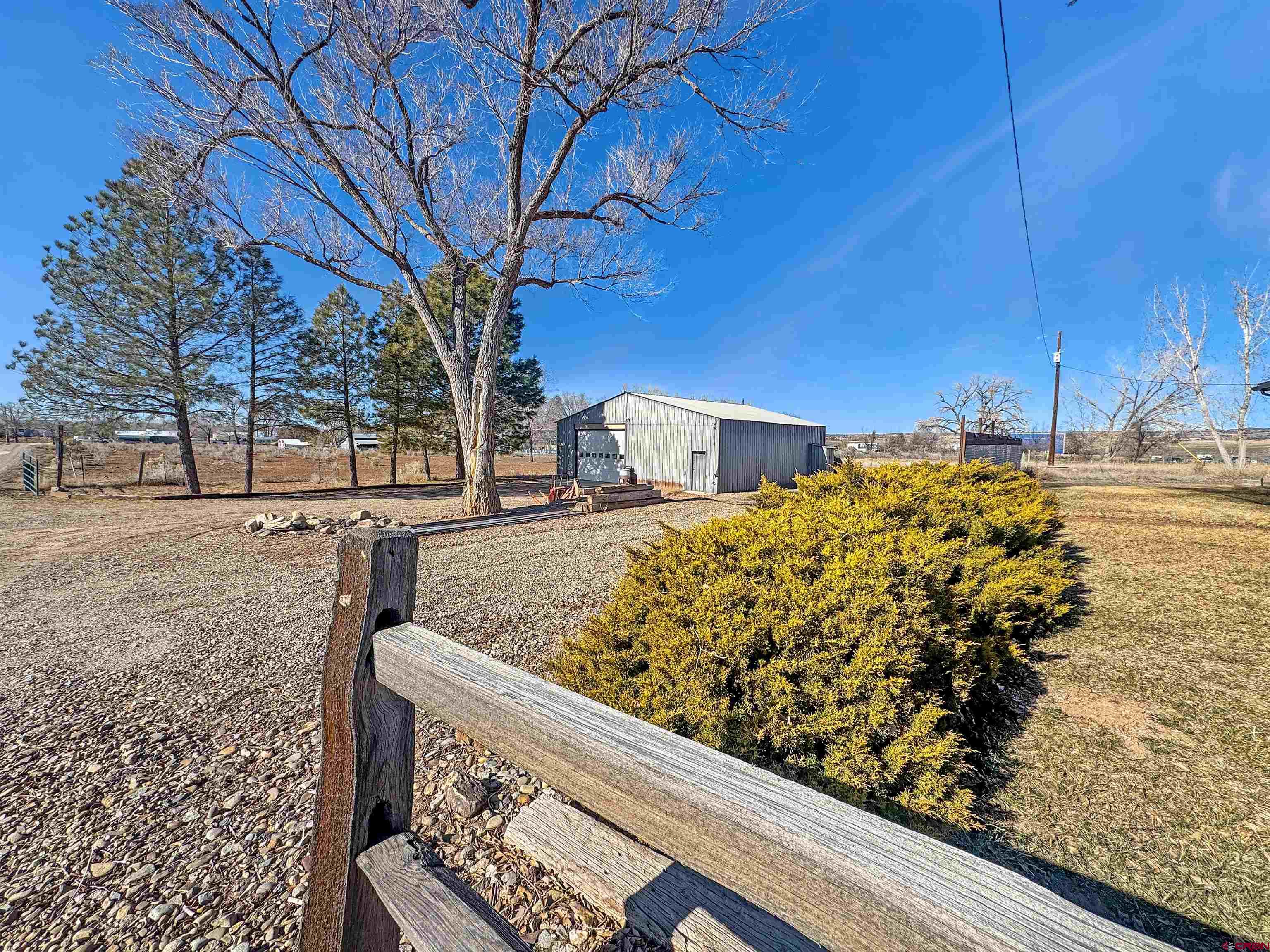 10880 Road 26 Cortez, CO 81321 - Photo 6 of 43 a view of a yard with wooden fence
