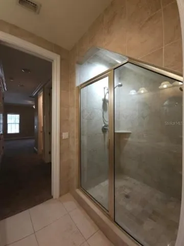 a bathroom with a glass shower door