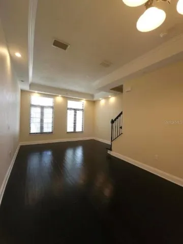 a view of a livingroom with wooden floor and a window