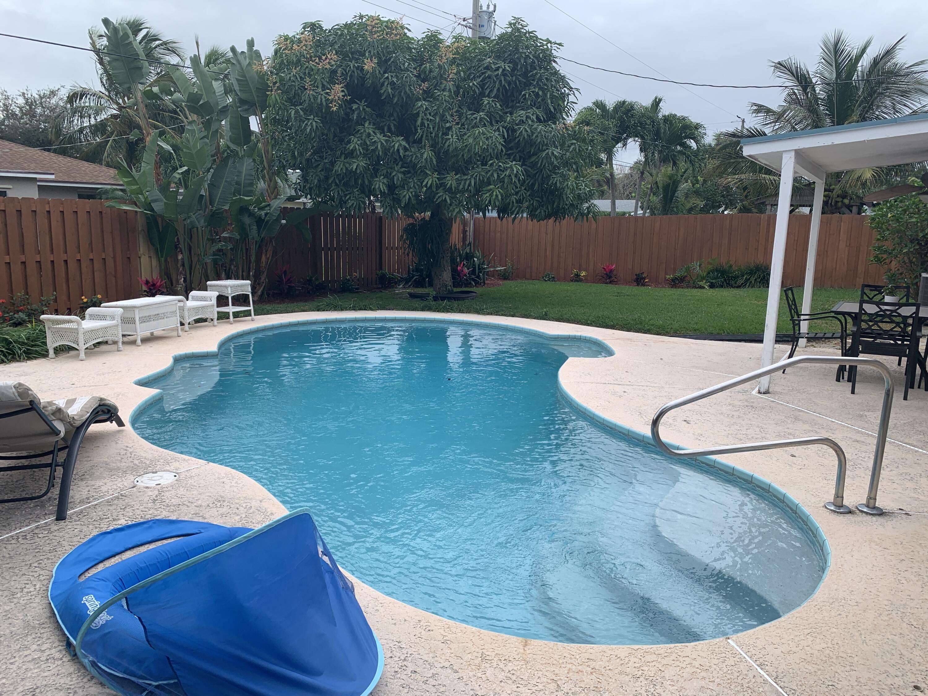 12 Pineview Road Jupiter, FL 33469 - Photo 3 of 5 a view of a swimming pool with a patio