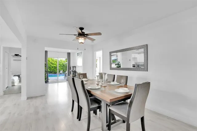 a kitchen with a refrigerator a stove a dining table and chairs