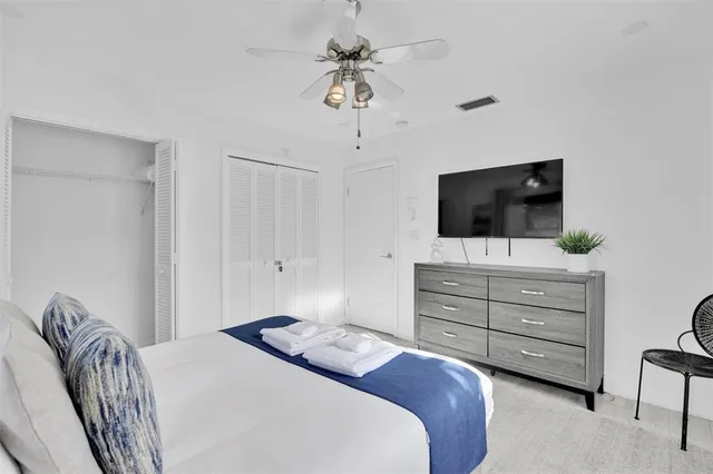 a bedroom with a bed and a flat tv screen