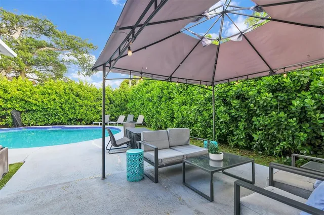 a view of a patio with a table chairs and a umbrella