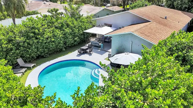 a front view of a house with a garden and yard