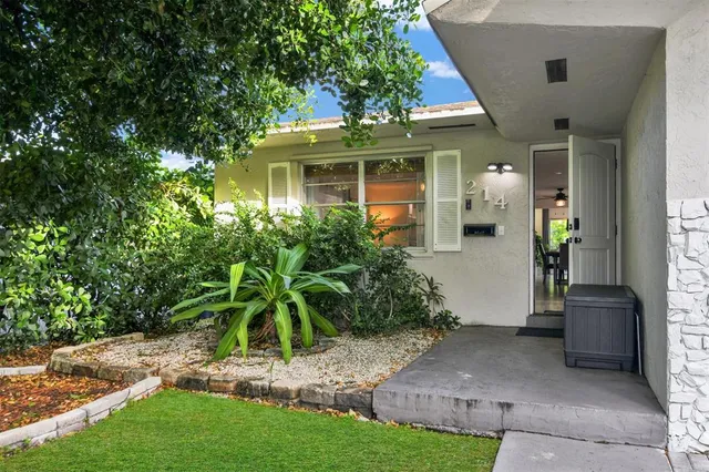 a view of a porch with furniture and garden