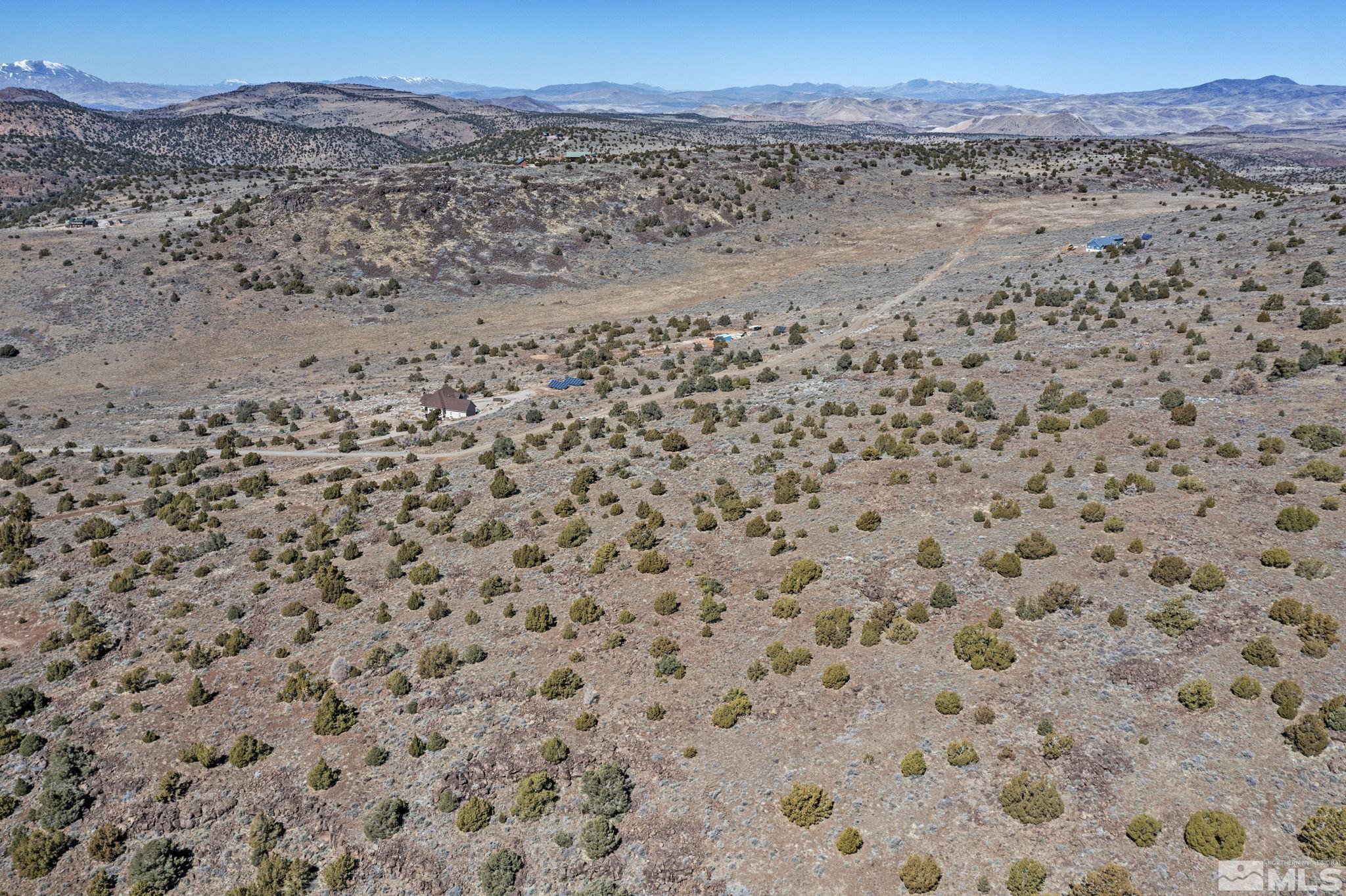 3150 Sheridan Road Reno, NV 89521 - Photo 12 of 27 a view of a dry yard with mountains in the background