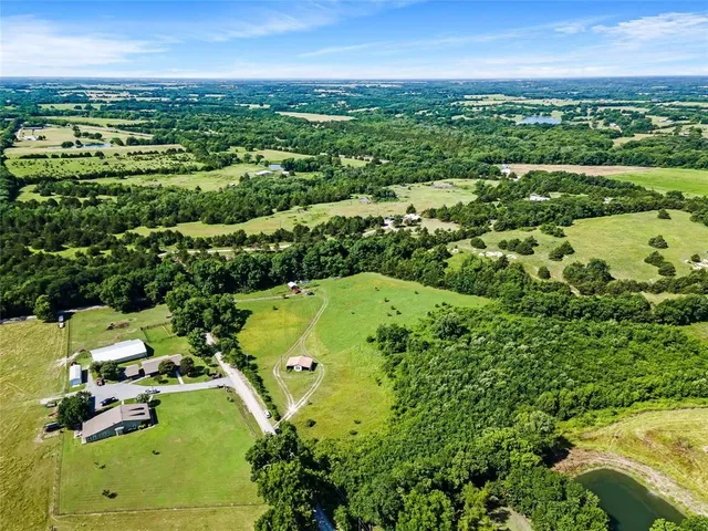 an aerial view of residential houses with outdoor space and street view