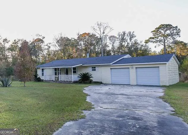 a view of a yard in front of a house with large tree