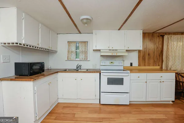 a kitchen with stainless steel appliances a stove microwave and cabinets