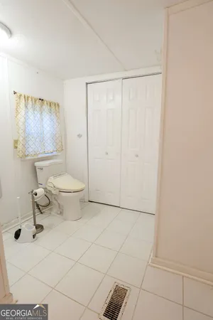 a bathroom with a toilet a sink and shower
