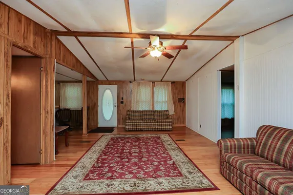 a hallway view with furniture and rug