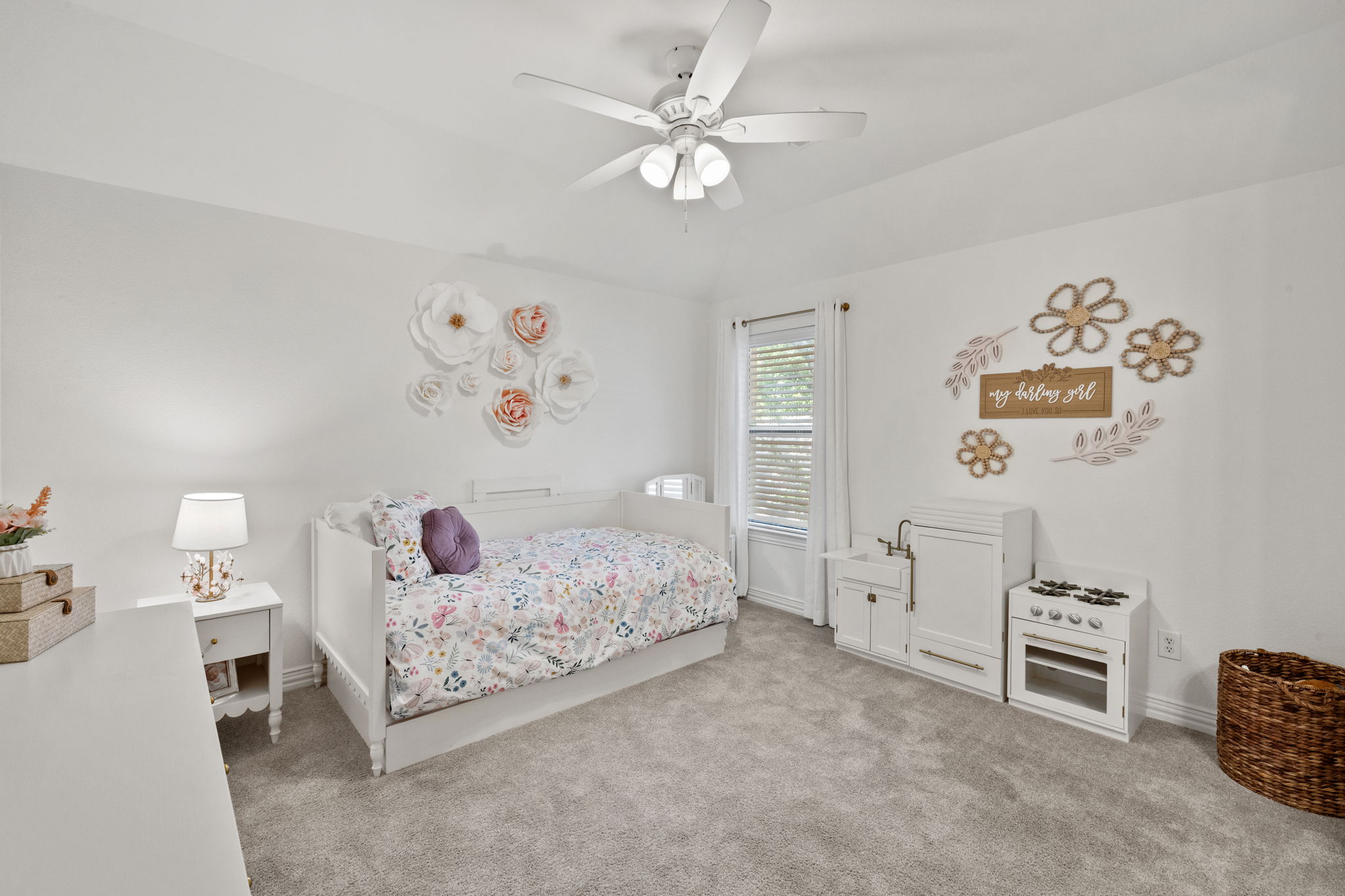 1124 Castle Path Round Rock, TX 78681 - Photo 32 of 40 A well-lit bedroom offers plush carpeting and a modern ceiling fan, creating a comfortable and inviting atmosphere.