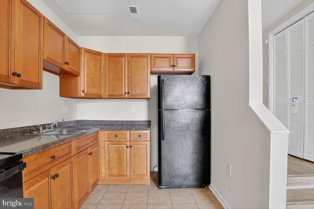 a kitchen with granite countertop white cabinets and stainless steel appliances