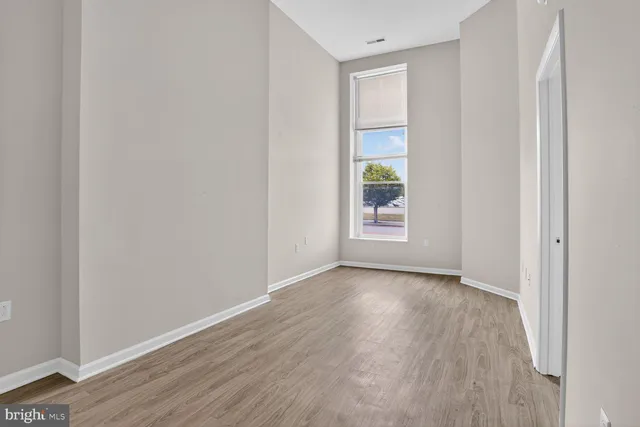 a view of front door with hallway and a bathroom