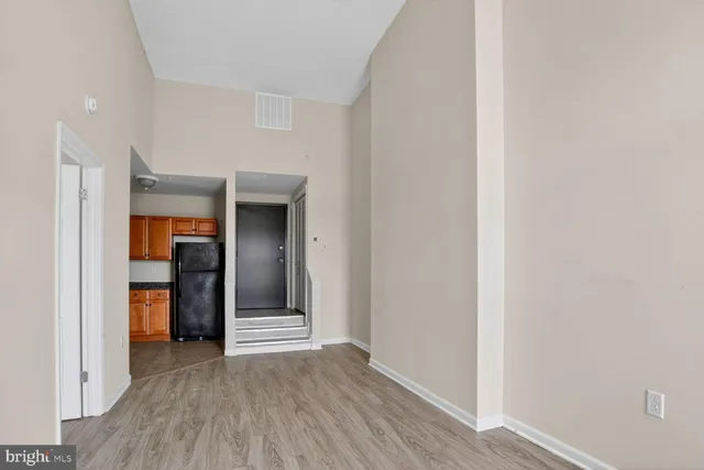 a view of a hallway with wooden shelves