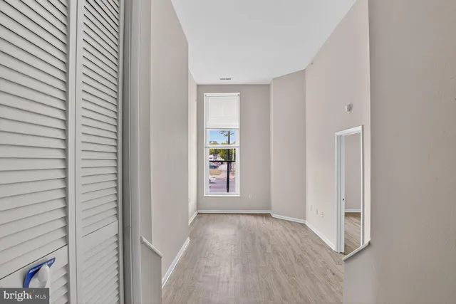 a view of a hallway view with wooden floor and staircase