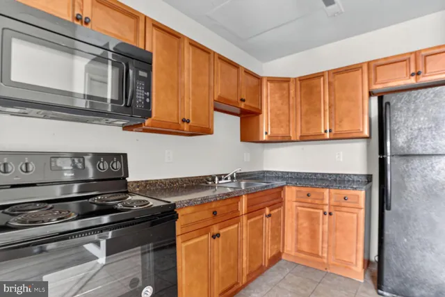 a kitchen with stainless steel appliances granite countertop a sink and cabinets