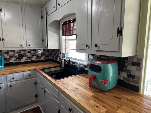 a kitchen with a sink and cabinets