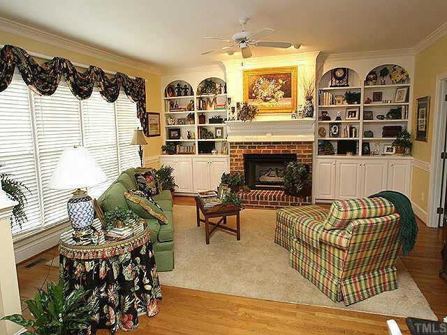 1408 Kings Branch Way Raleigh, NC 27614 - Photo 2 of 9 The family room flows off the kitchen and boasts double built-ins w/ TV cabinet, gas logs FP and custom window treatments that convey! Other
