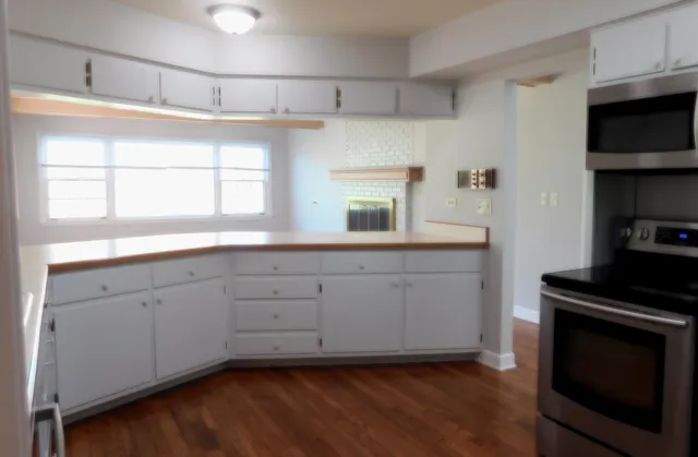 a kitchen with sink cabinets and wooden floor