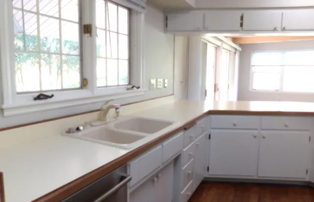 a view with a sink and mirror with window
