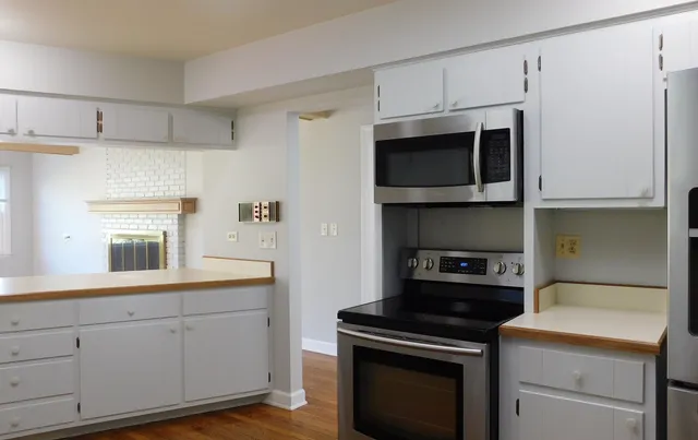 a kitchen with cabinets and steel appliances