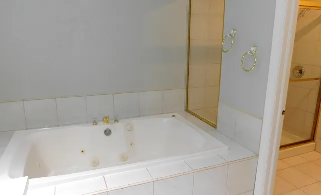 a bathroom with a bathtub and shower