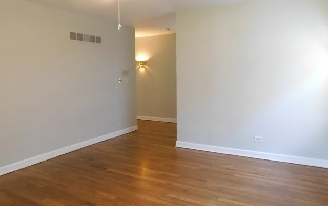 a view of a room with wooden floor