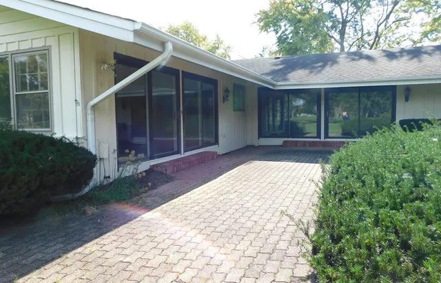 a view of backyard with large trees and wooden fence