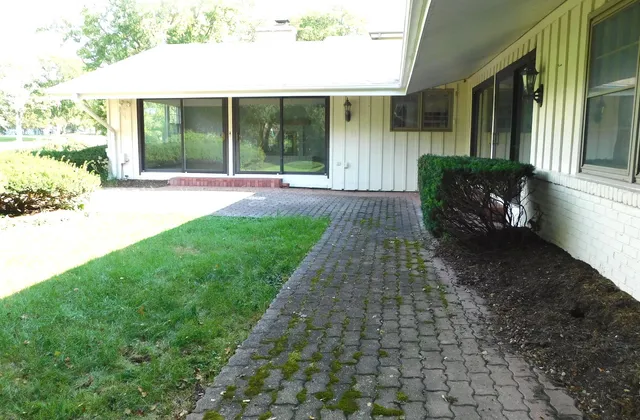 a view of house with backyard