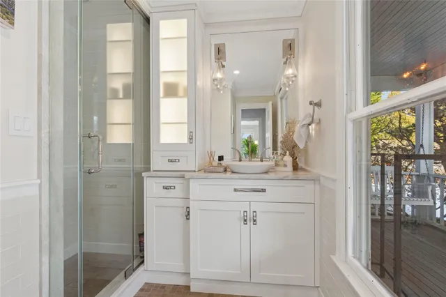 a kitchen with white cabinets and a window