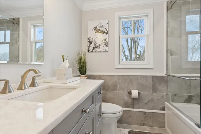 a spacious bathroom with a shower a sink and a mirror