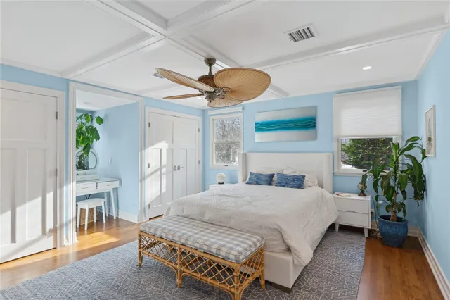 a view of a hallway with wooden floor and windows