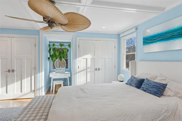 a bedroom with a bed potted plant with the outer view