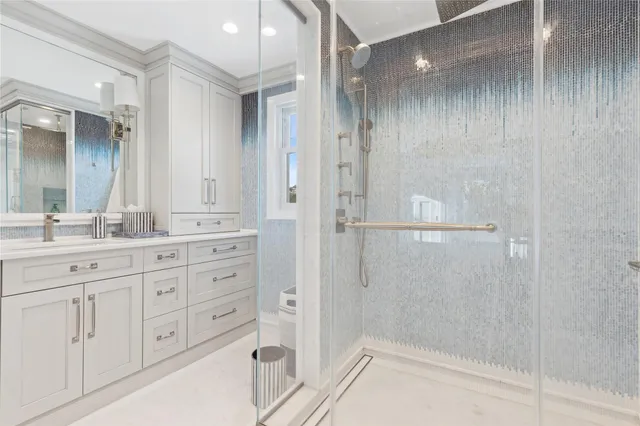 a bedroom with a bed mirror and window