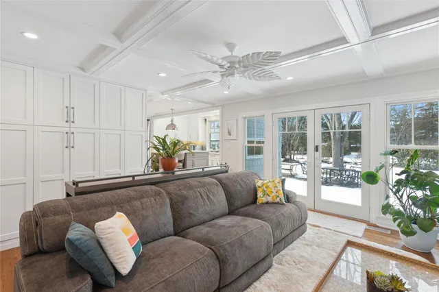 a living room with furniture and potted plants