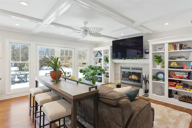 a living room with furniture a fireplace and a flat screen tv
