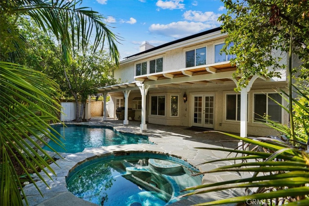 a view of a house with pool and sitting area