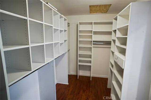 a view of walk in closet with empty racks
