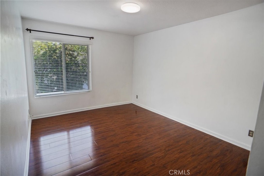 5530 Buffwood Place Agoura Hills, CA 91301 - Photo 16 of 22 a view of an empty room with wooden floor and a window